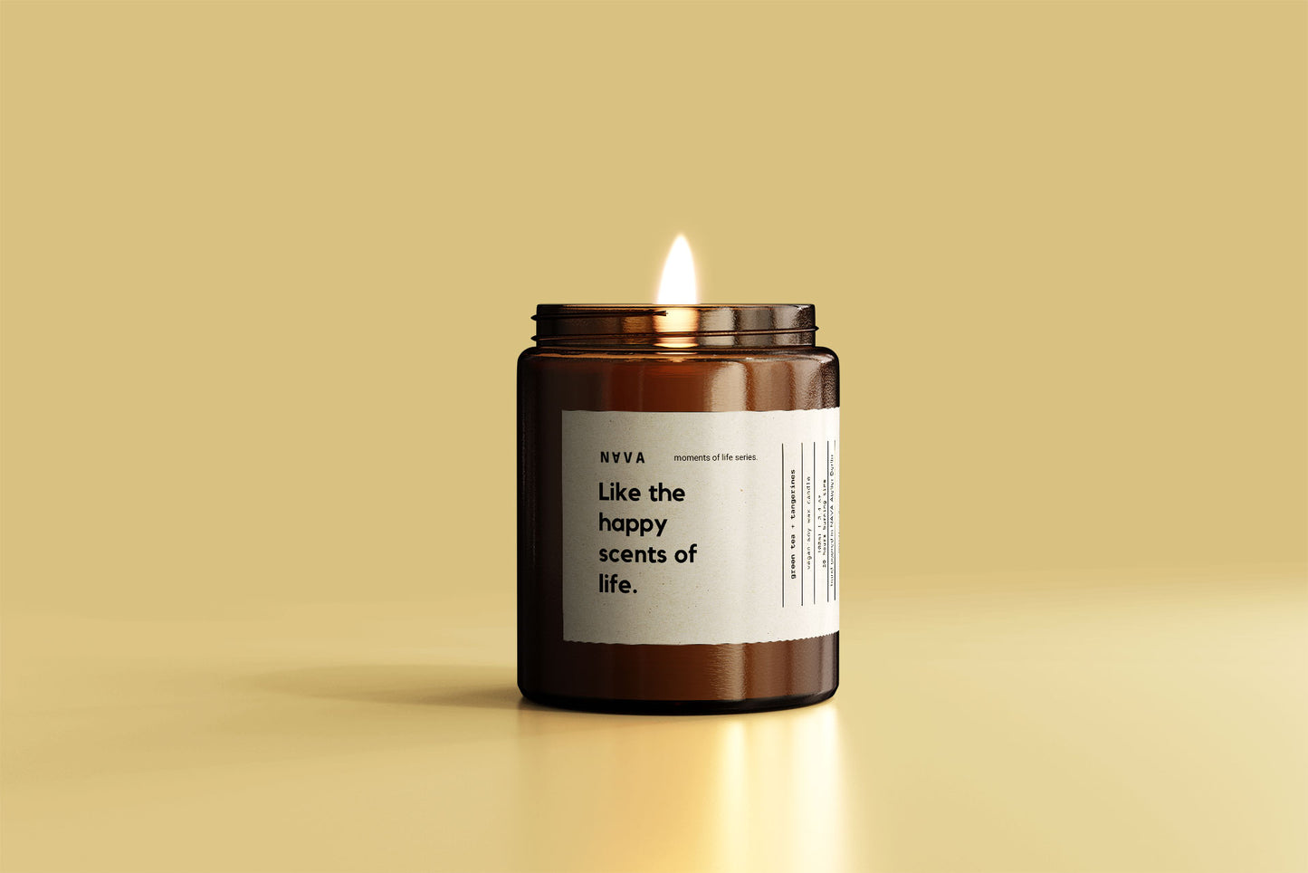 NAVA Happy Scents of Life candle tilted on a warm yellow surface