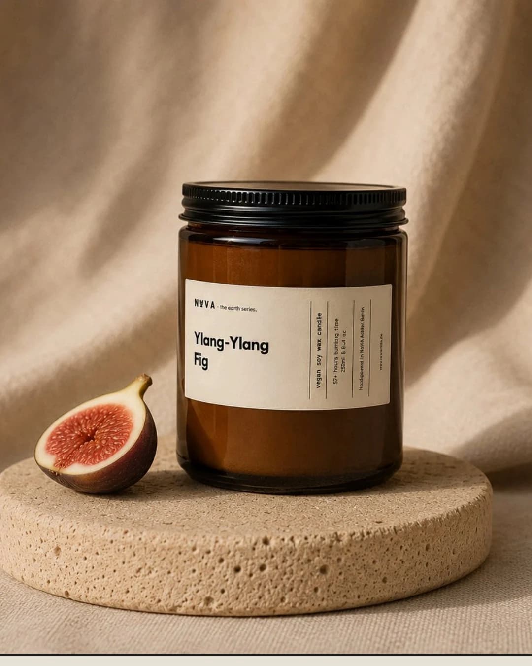 NAVA Ylang-Ylang and Fig candle beside a fresh fig